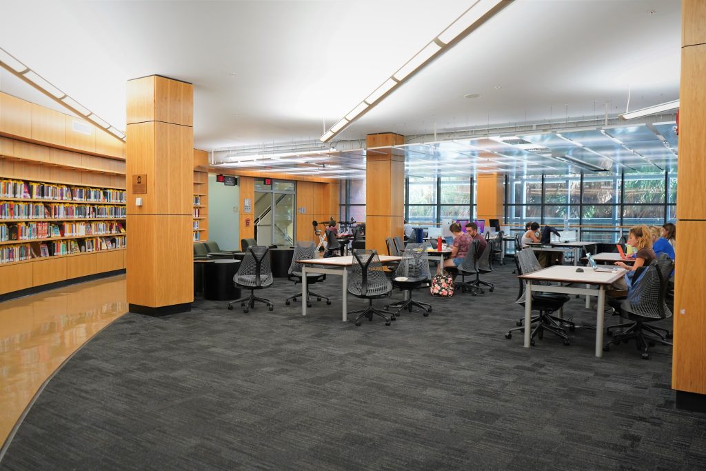 A large room with ample tables for social studying