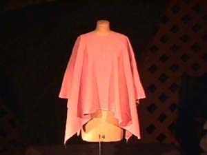 Poncho displayed on a dress form.