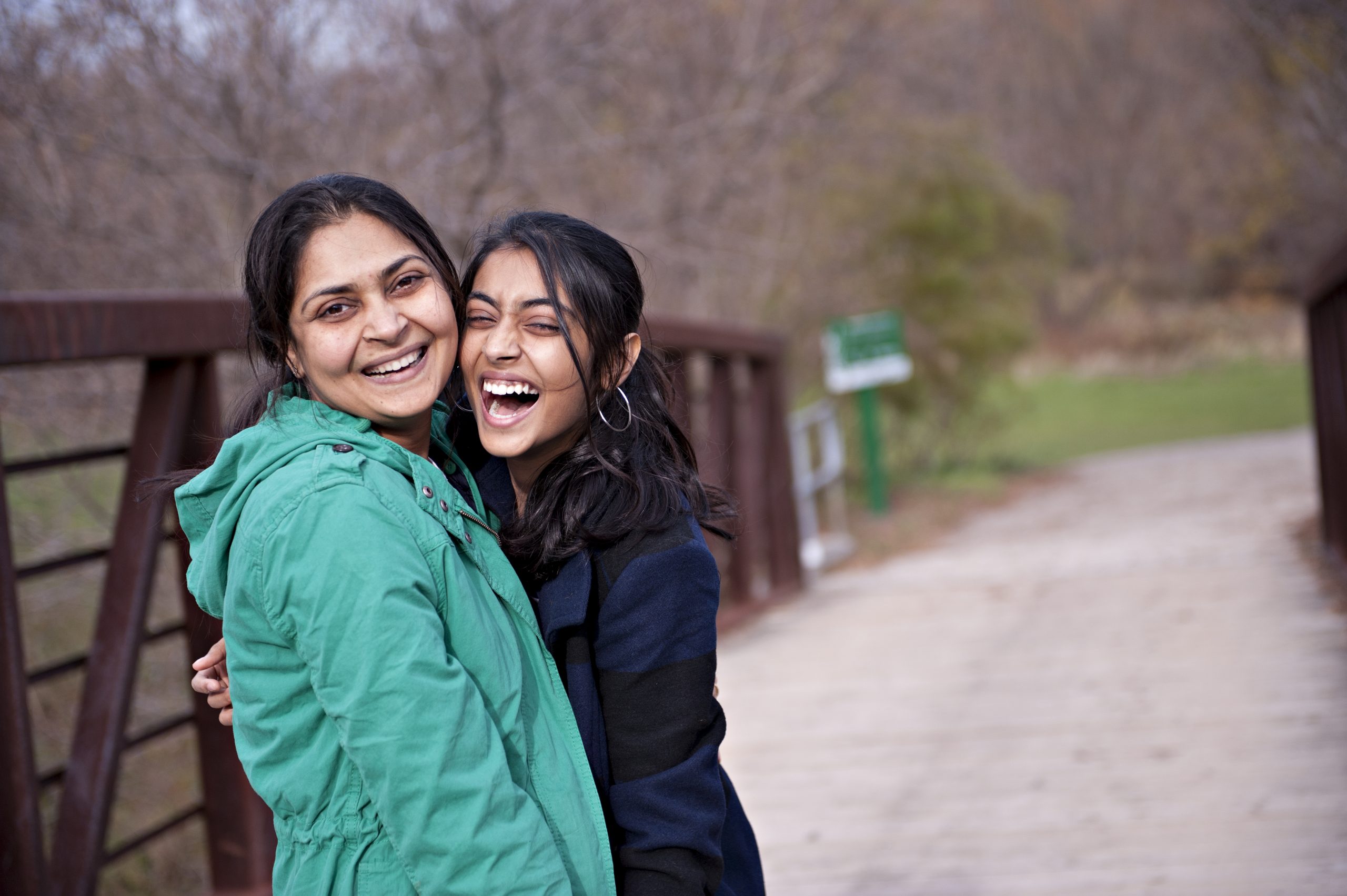 Photograph of two young women in jackets laughing