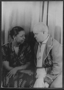 Ethel Waters sits to the left of Carl Van Vechten, American writer and photographer, who was a patron of the Harlem Renaissance. They are facing each other and looking each other in the eyes.