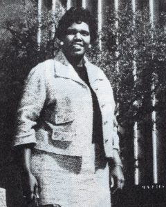 Barbara Jordan standing and smiling.