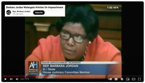 YouTube video of Barbara Jordan with glasses in orange jacket with polka dot shirt speaking to congress during Nixon Impeachment Hearings in 1974.