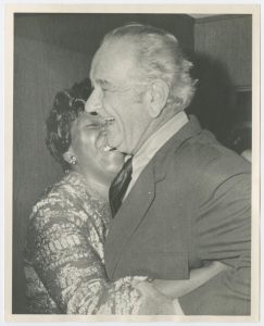 Close-up of Barbara Jordan and Lyndon B. Johnson laughing and embracing at a fundraiser for Jordan at the Rice Hotel in Houston, Texas.