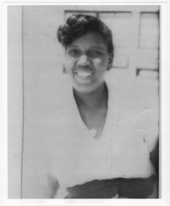 Barbara Jordan from the waist up at age 15, smiling.