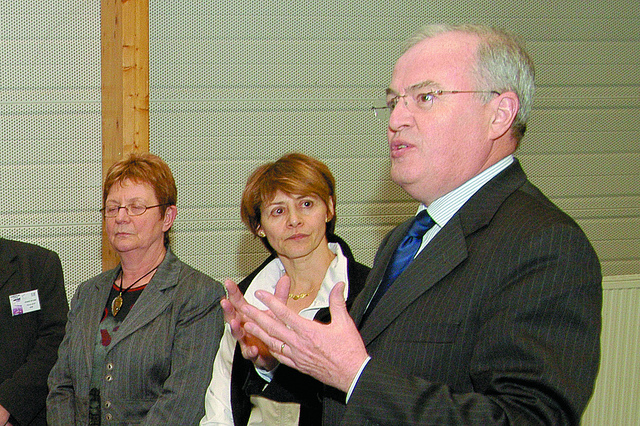 A man speaking to a group of women