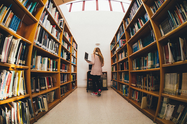 A young student doing research in a library