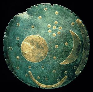 Circular blue green disc with gold stars and moon
