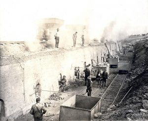 Coalworkers next to cart rail lines