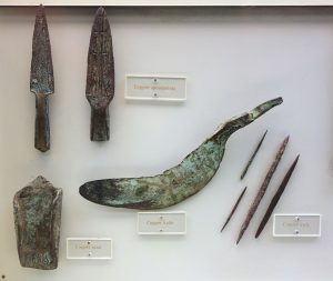 Labeled examples of copper knife, spearpoints, awls, and spade