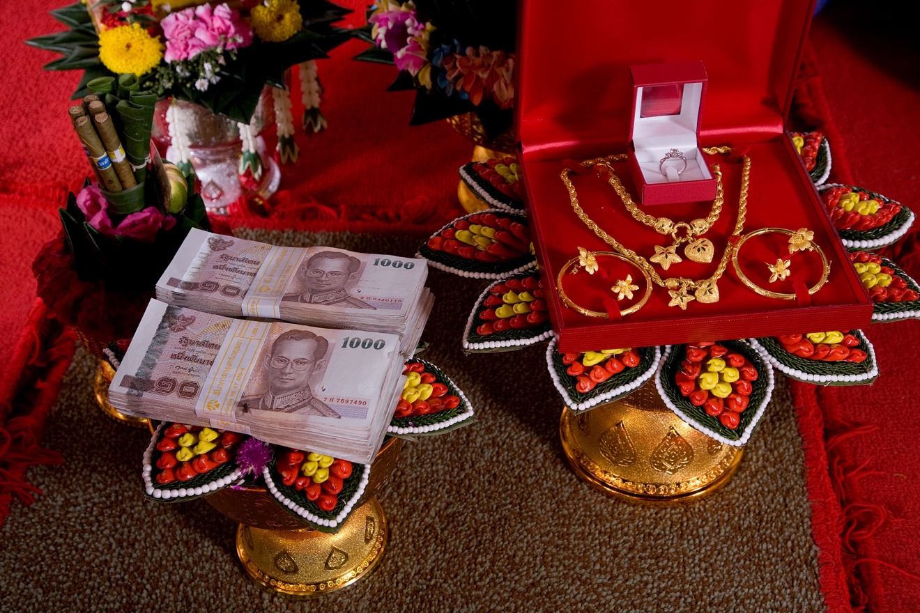 Banknotes and jewelry with red background