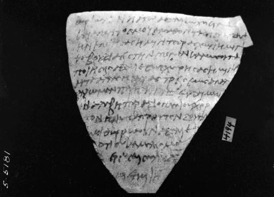 Writing on surface of triangular fragment with point facing down