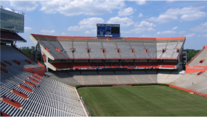 Sunlit view of empty stadium under blue sky with clouds