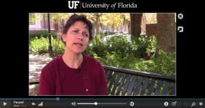 Dr. Victoria Pagan sits on a bench in a courtyard