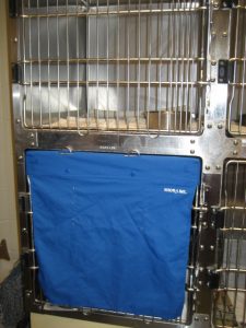 Blue canvas cover for the door of a cat cage