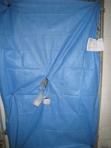 Blue surgery drape material covering a run door