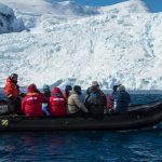 Group of people on boat near ice