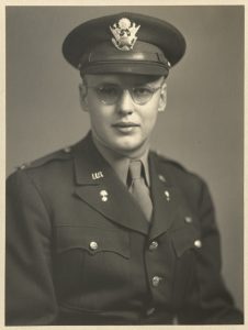 Sepia photograph of John, who is in military dress uniform and is looking straight at the camera and not smiling.